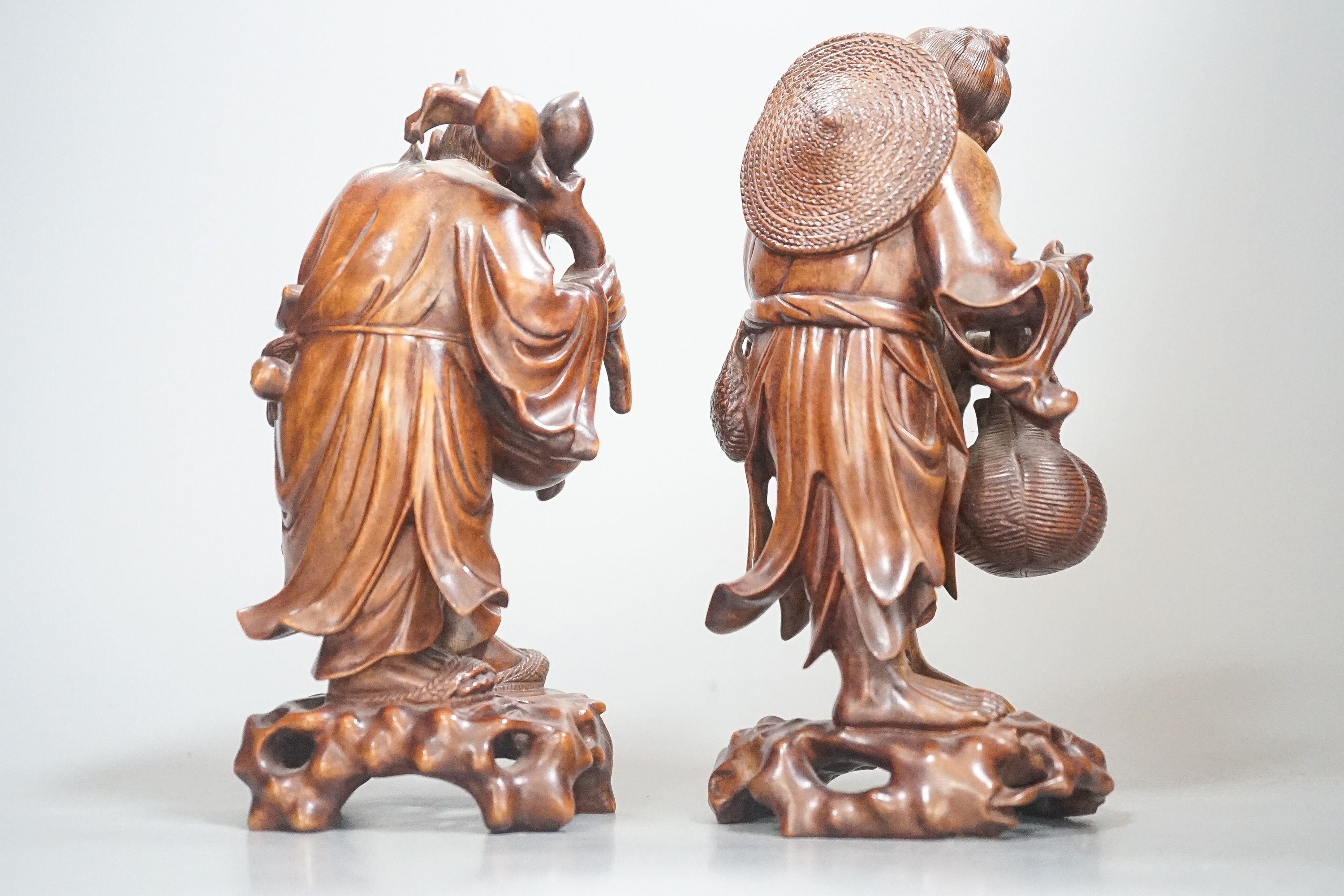 Two Chinese hardwood figures of a fisherman and a old man holding peaches 16cm